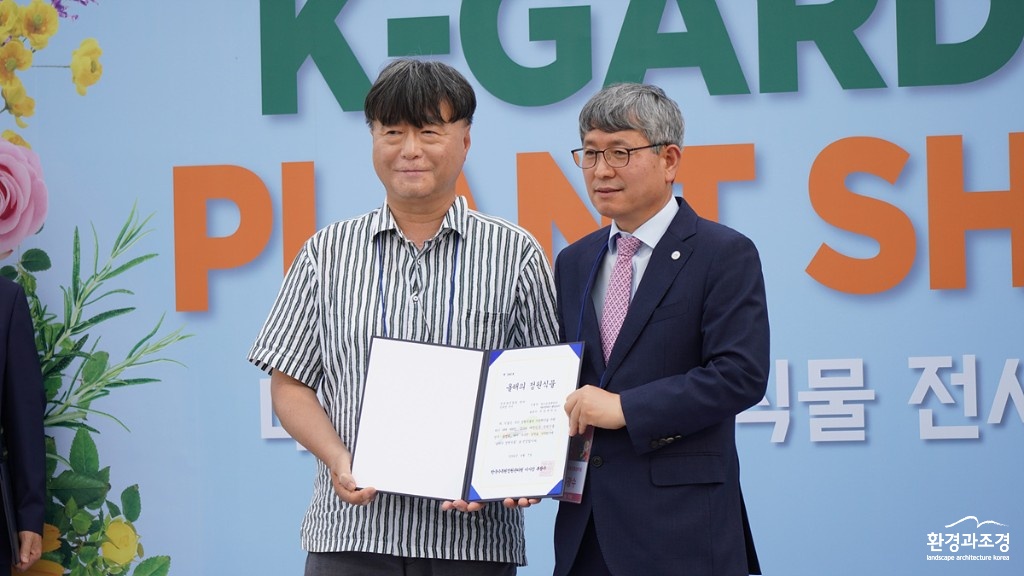 3. 국내육성품종 분야 신규성 우수로 한국수목원정원관리원 이사장상을 받은 알스트로메리아 ‘제이엔에이 웨딩피치’ 출품자가 류광수 이사장과 기념촬영을 하고 있다..jpg